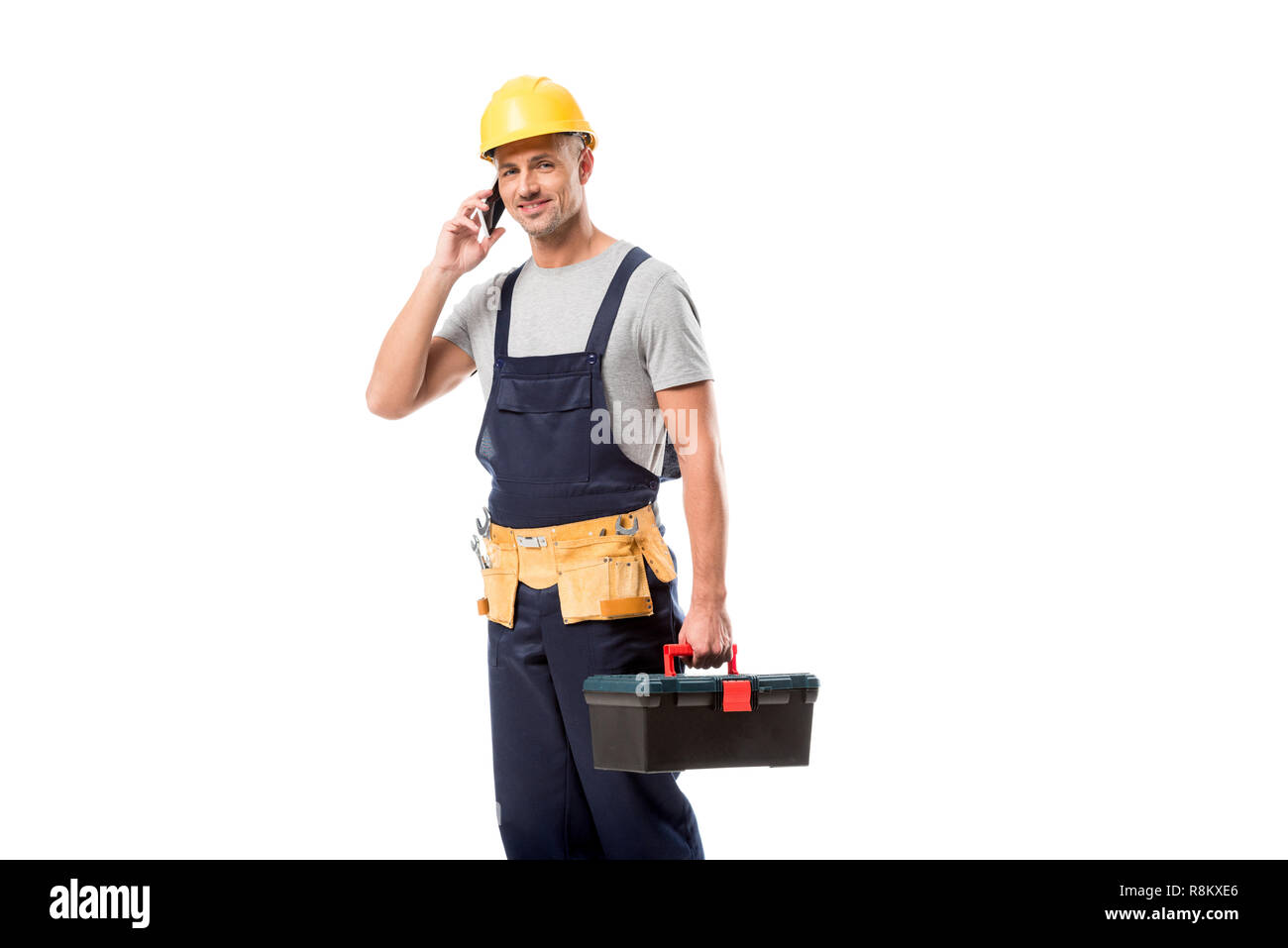 construction worker in helmet talking on smartphone isolated on white Stock Photo