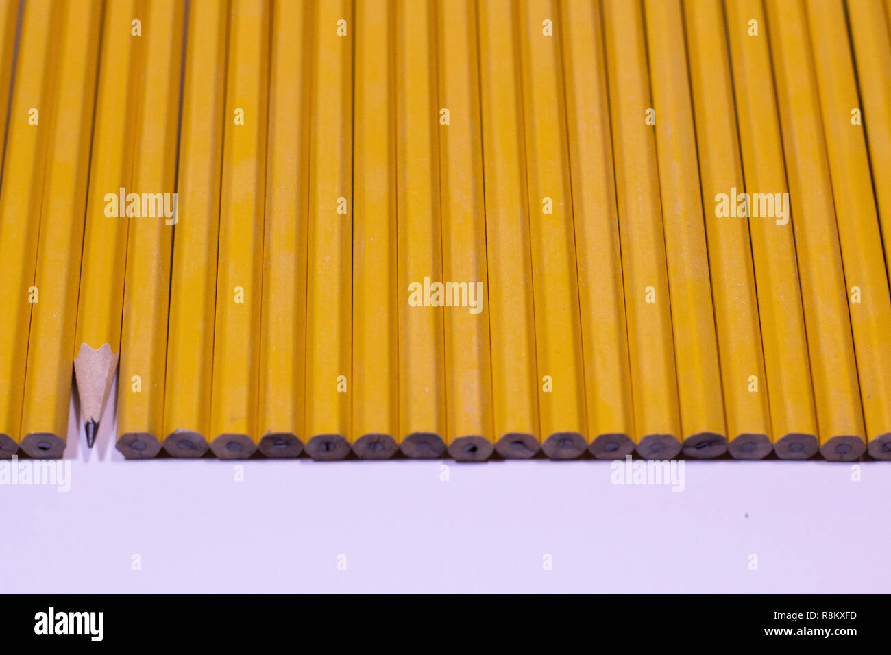 Forty five degree angle of pencils lined up in a row background Stock Photo