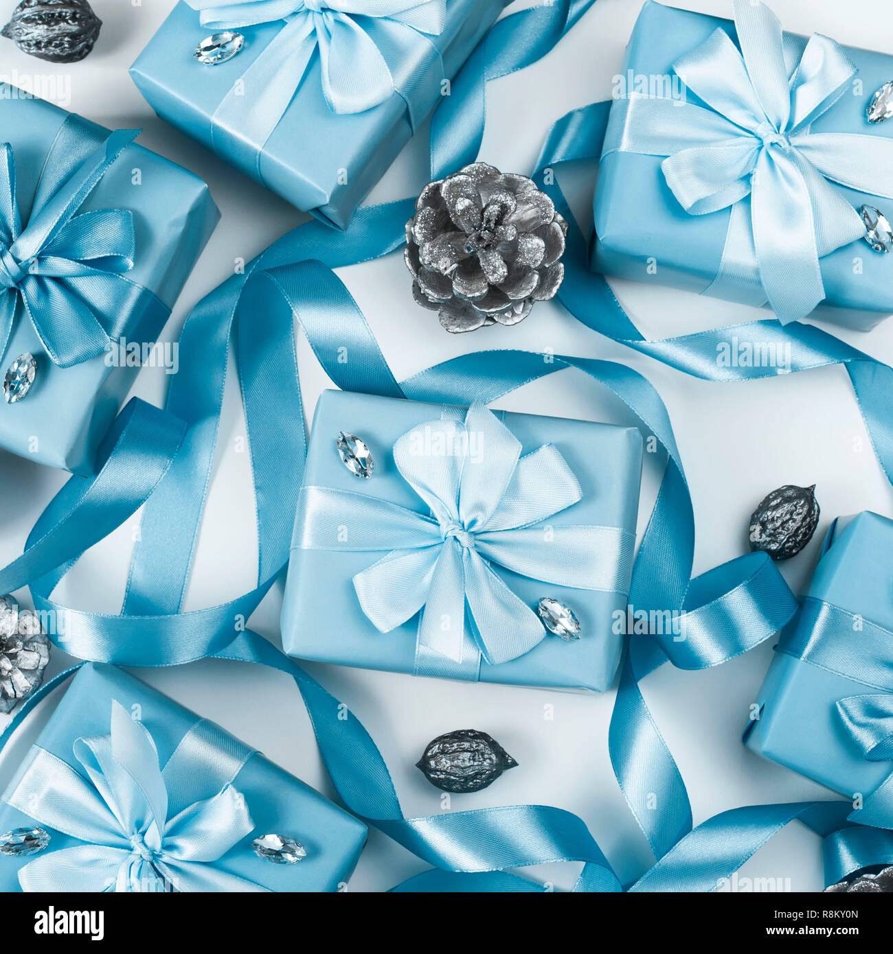 Christmas boxes with gifts blue color on white background cones nuts decor. Top view flat lay square Selective focus. Square Stock Photo