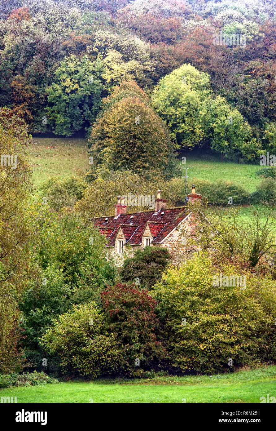An autumn view of a rural house nestling in the Cotswold countryside. Stock Photo