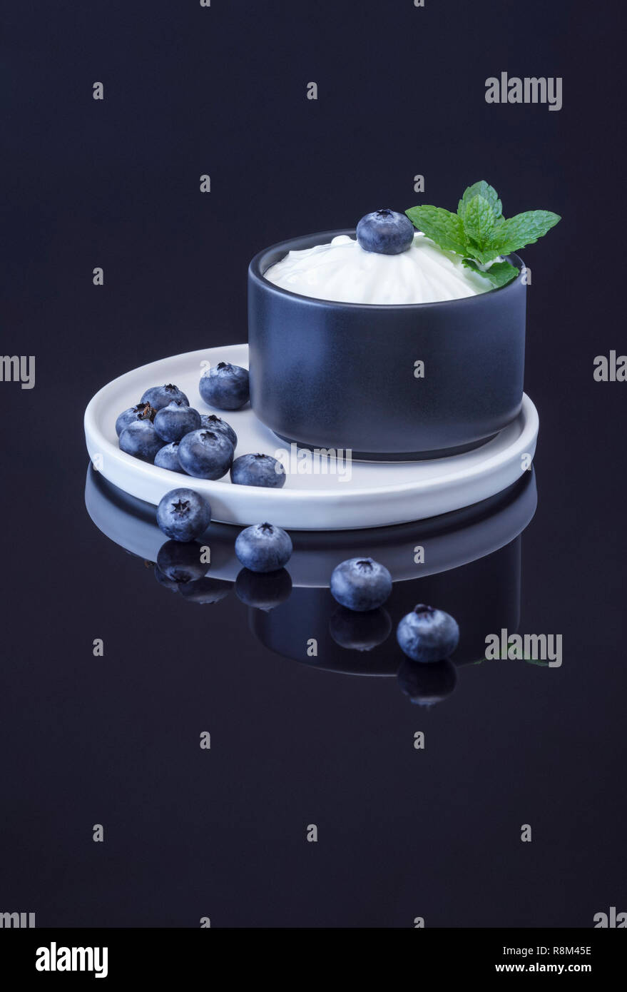 Blueberries and Quark garnished with fresh mint Stock Photo