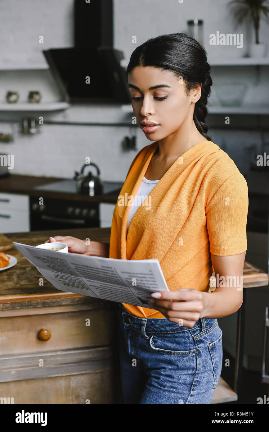 Beautiful Mixed Race Girl In Orange Shirt Holding Cup Of Coffee