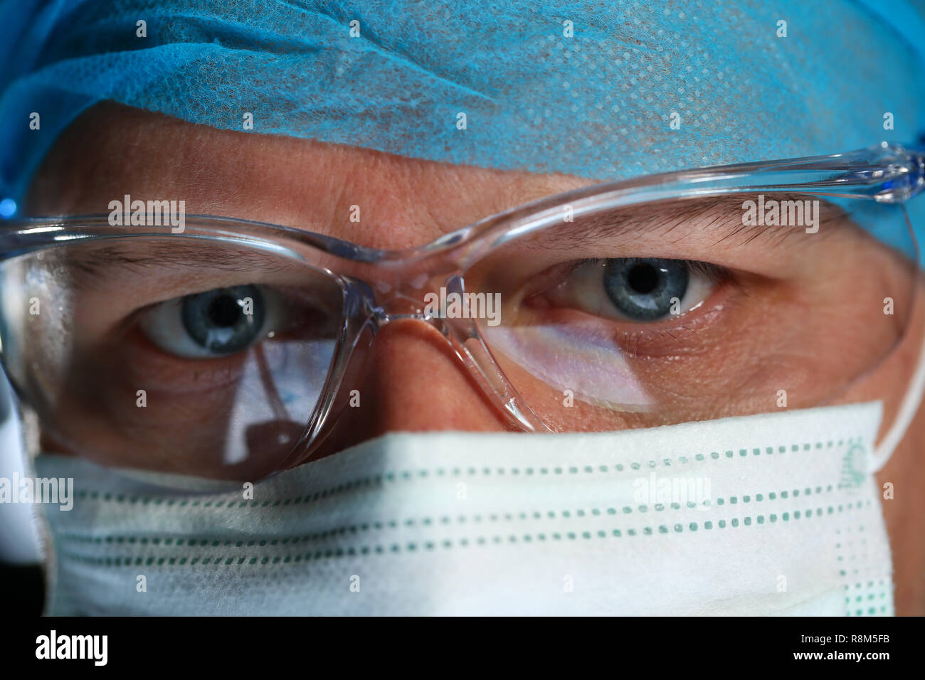 Handsome male physician face wearing protective mask Stock Photo