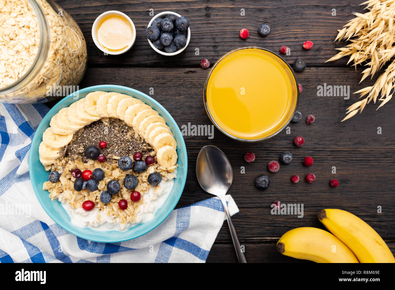 Healthy Fitness Breakfast With Fresh Orange Juice Oatmeal With Bananas Blueberries And Cranberries Chia Seeds And Yogurt On Dark Wooden Board With Stock Photo Alamy