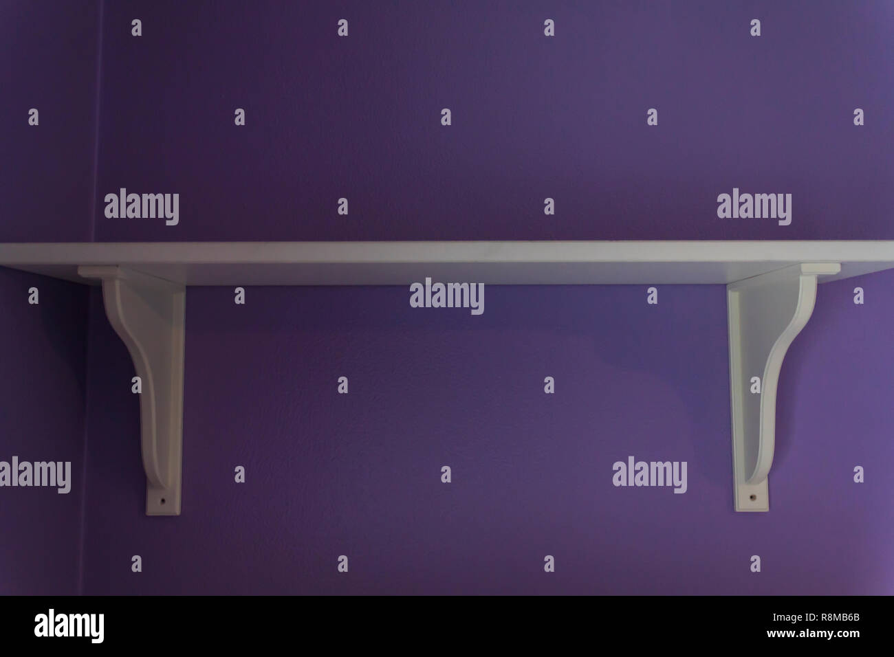White Sagging Shelf on purple wall Stock Photo Alamy