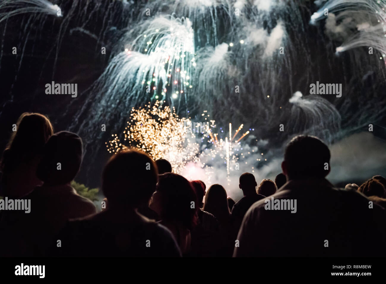 Crowd watching fireworks and celebrating new year eve Stock Photo