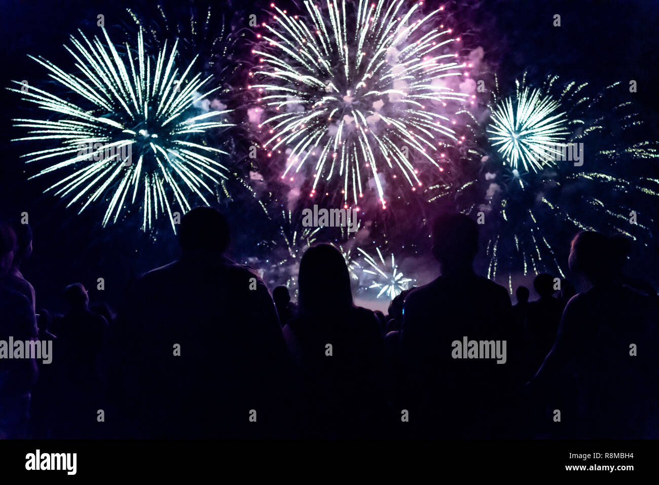 Crowd watching fireworks and celebrating new year eve Stock Photo