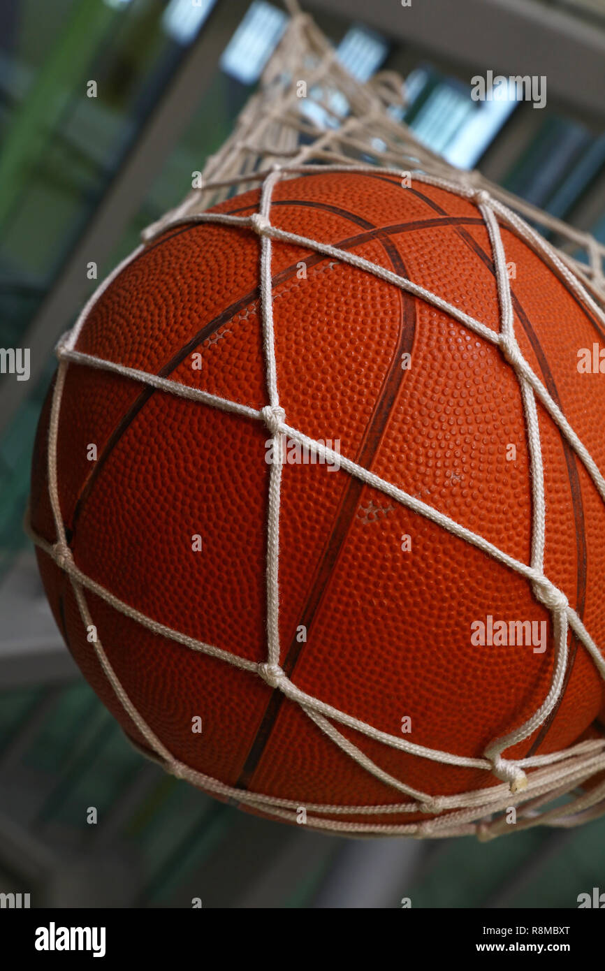 Close up one basketball ball hanging in mesh sack, low angle side view  Stock Photo - Alamy