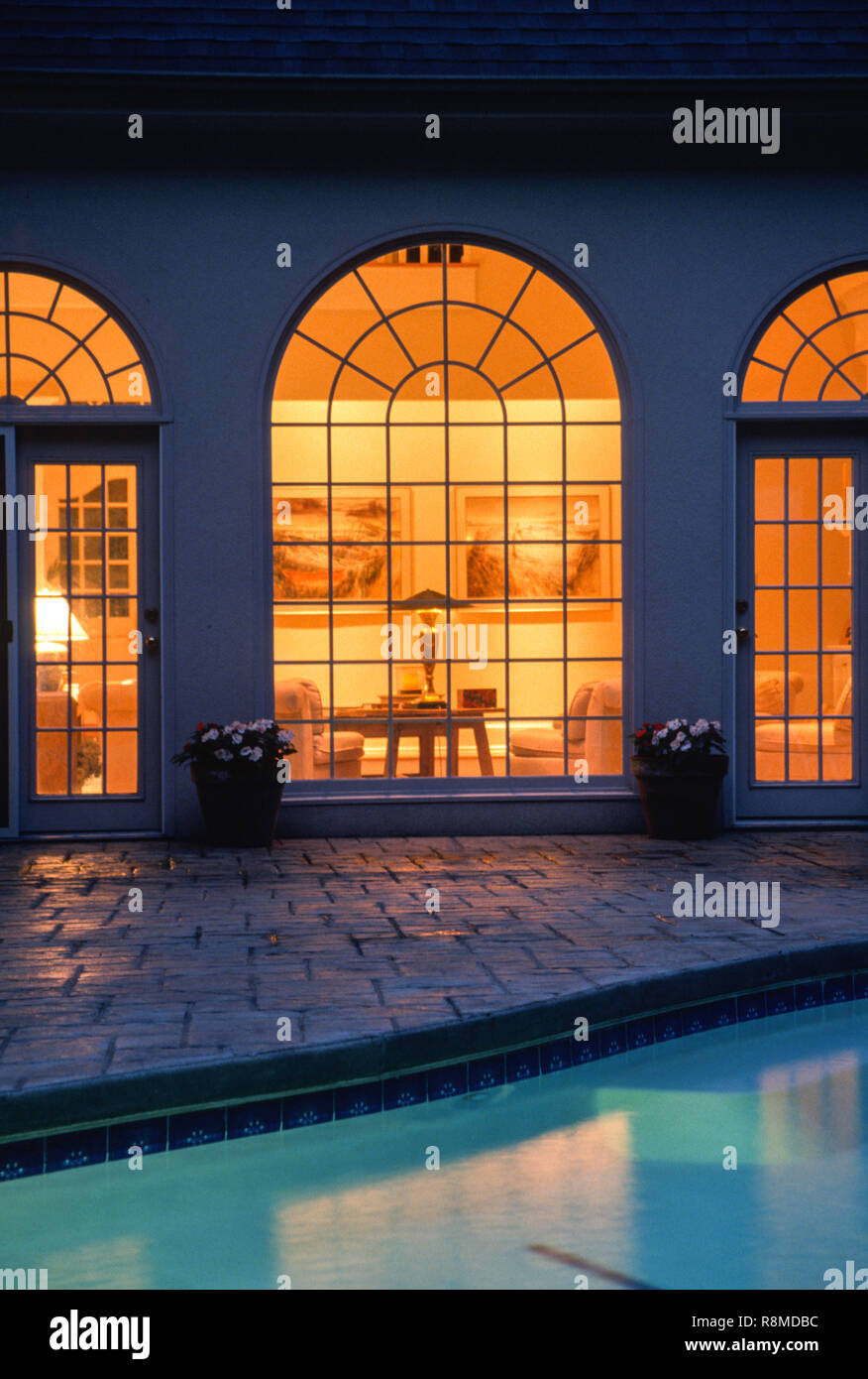 Residential home at night with lit windows, USA1998 Stock Photo