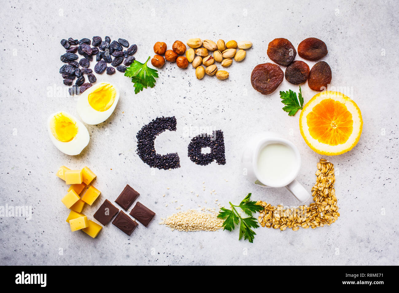 Healthy products sources of calcium. Top view, food background, Ca ingredients: cereals, dried fruits, dairy products, orange, nuts, greens and cheese Stock Photo