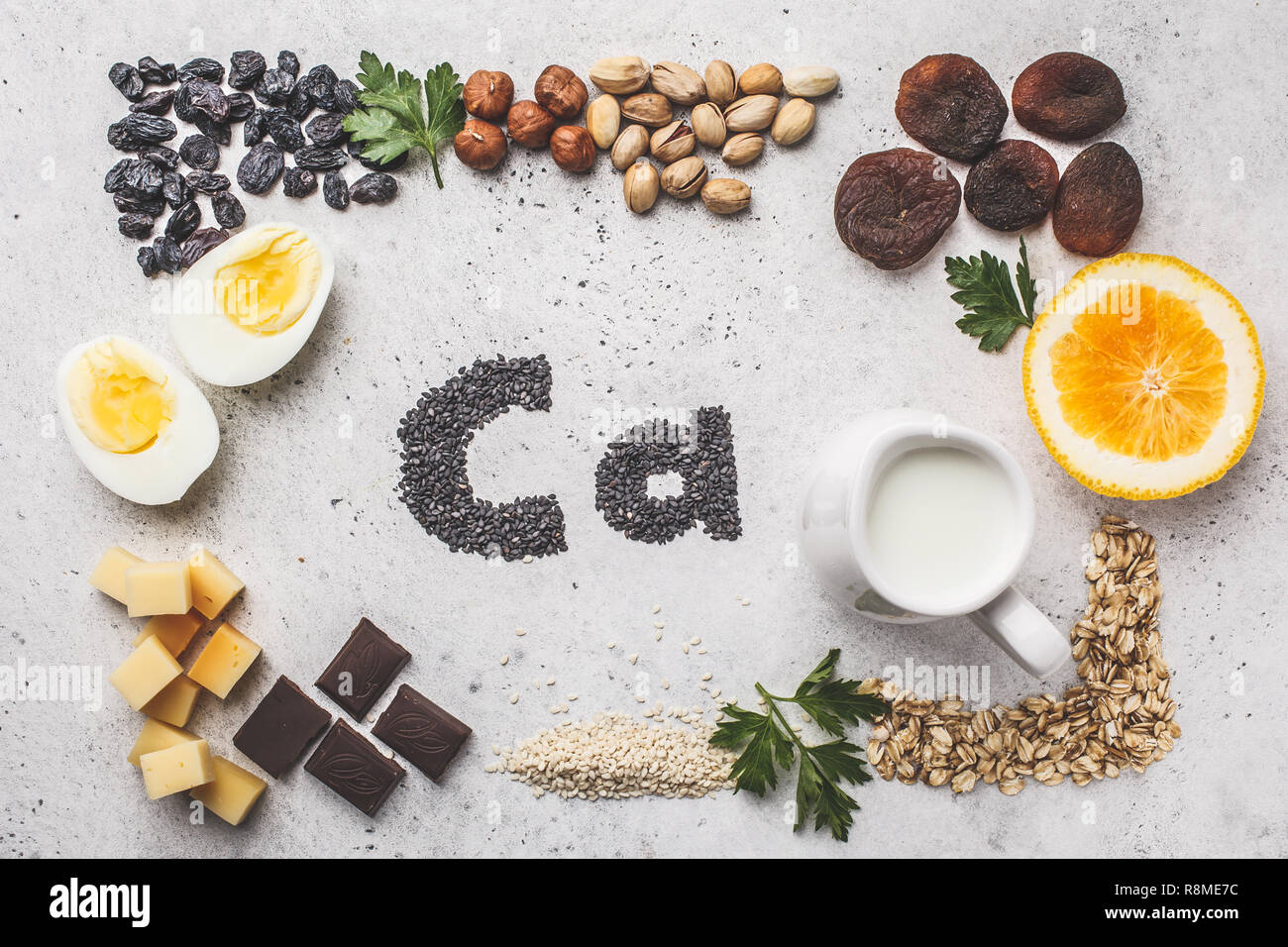 Healthy products sources of calcium. Top view, food background, Ca ingredients: cereals, dried fruits, dairy products, orange, nuts, greens and cheese Stock Photo