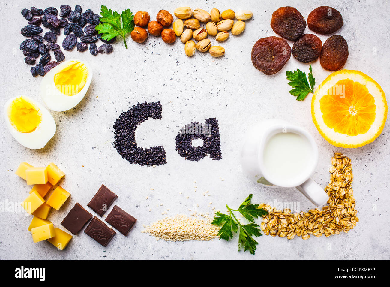Healthy products sources of calcium. Top view, food background, Ca ingredients: cereals, dried fruits, dairy products, orange, nuts, greens and cheese Stock Photo