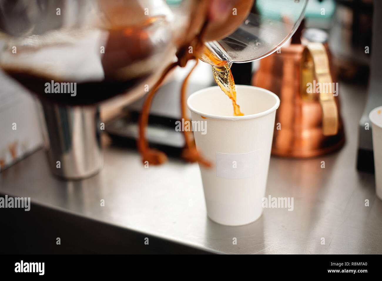 Coffee poured into a white paper cup. Drip brewing coffee Stock Photo ...