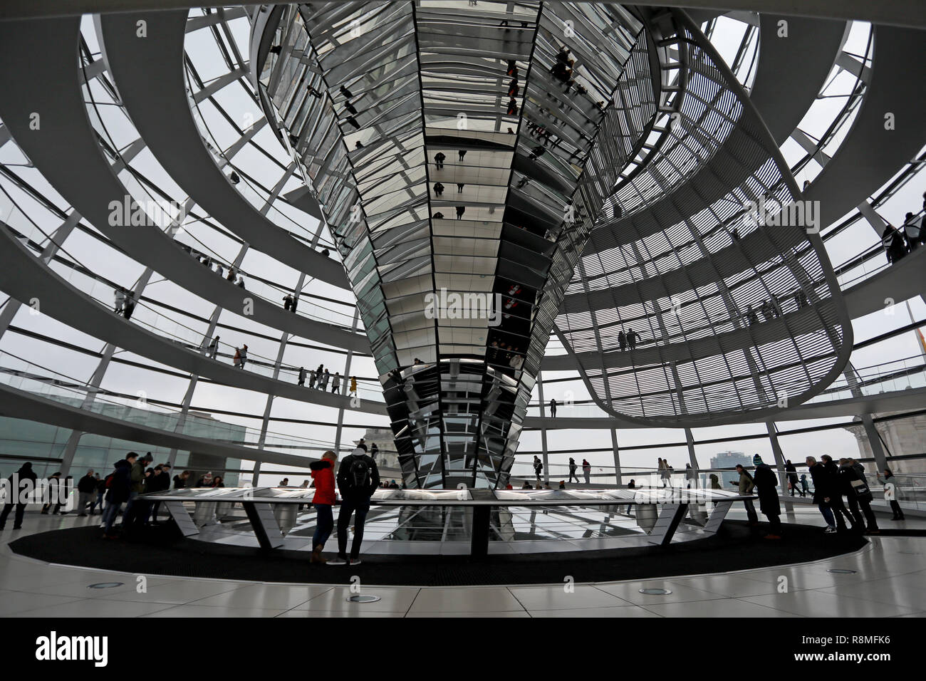 Berlin / Germany - December 15 2018: Visitors walk around the glass dome on top of the Reichstag Building, the German parliament, in central Berlin. Stock Photo