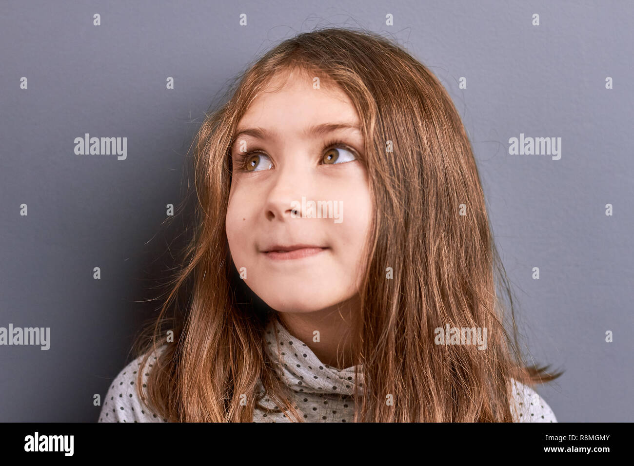 Portrait of little girl looking away Stock Photo - Alamy