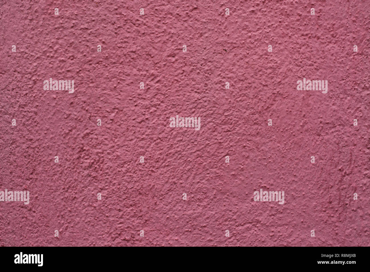 Dirty pink painted stucco wall on Burano Island in the Venetian Lagoon near Venice, Italy. Background texture. Stock Photo
