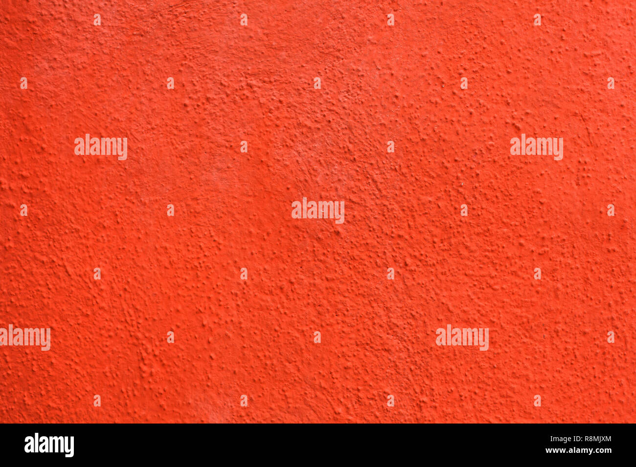 Bright orange painted stucco wall on Burano Island in the Venetian Lagoon near Venice, Italy. Background texture. Stock Photo