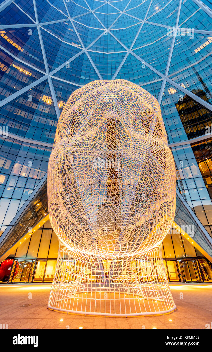 Wonderland sculpture by Jaume Plensa in the front of the Bow Tower Stock Photo