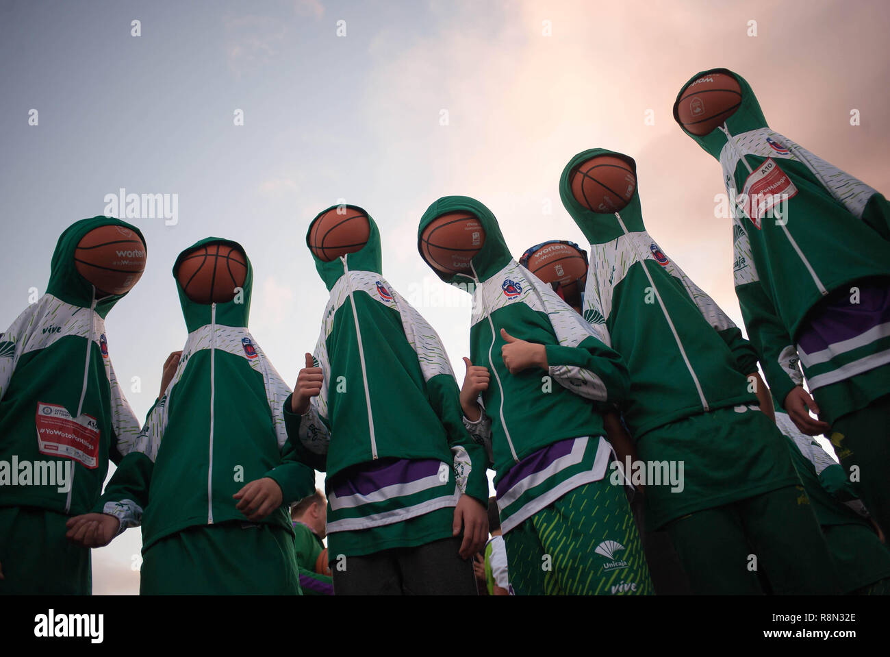 Malaga, Spain. 16th Dec, 2018. Participants are seen hooded with their basketballs before the first attempt to beat the Guinness World Record of people bouncing basketballs at the same time during five minutes, outside the Sport Palace Jose Maria Martin Carpena in Malaga. The previous record was got in Palestine in 2010 with 7.756 people. Credit: SOPA Images Limited/Alamy Live News Stock Photo