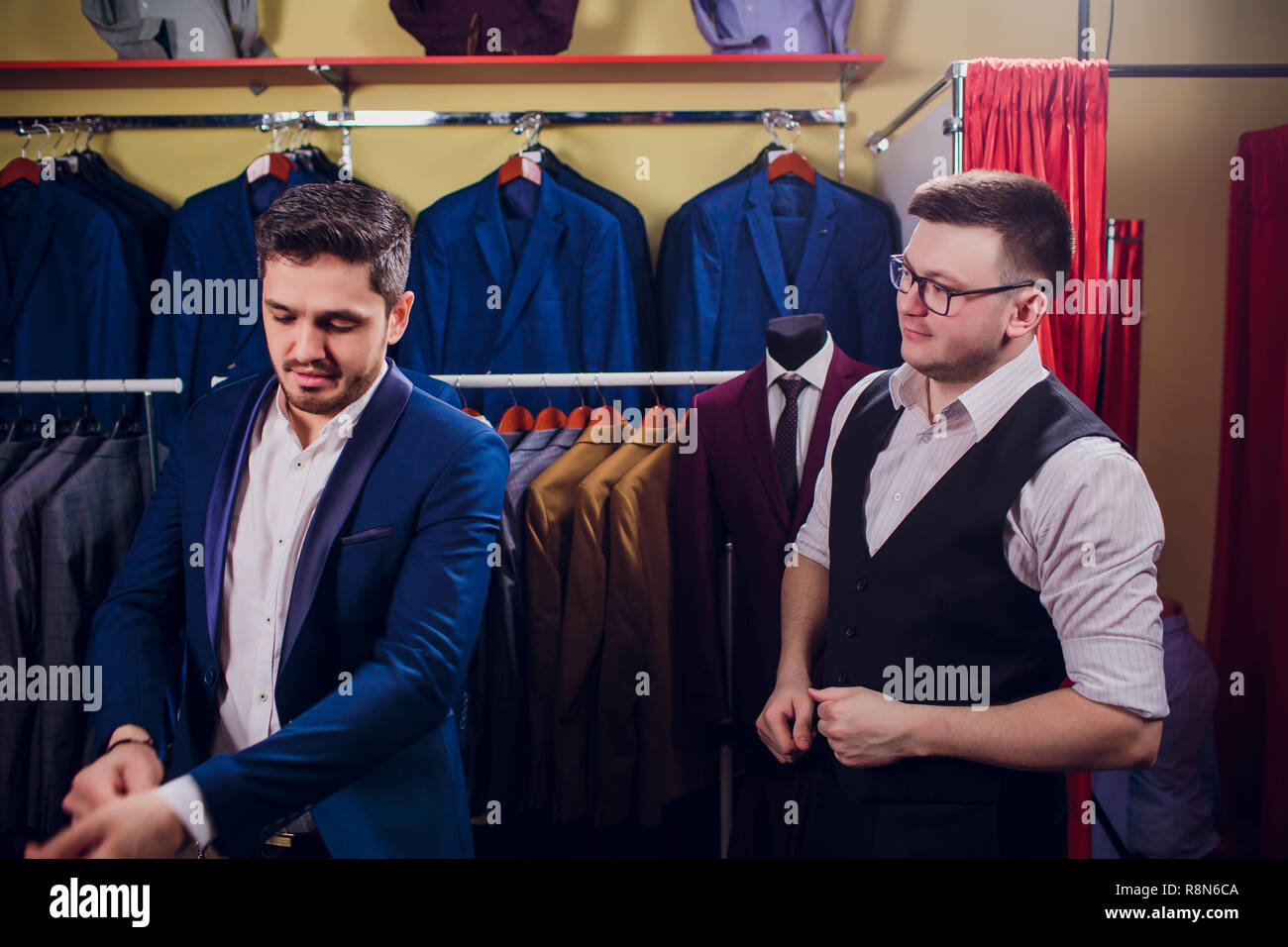 man is buying suit in store Stock Photo Alamy