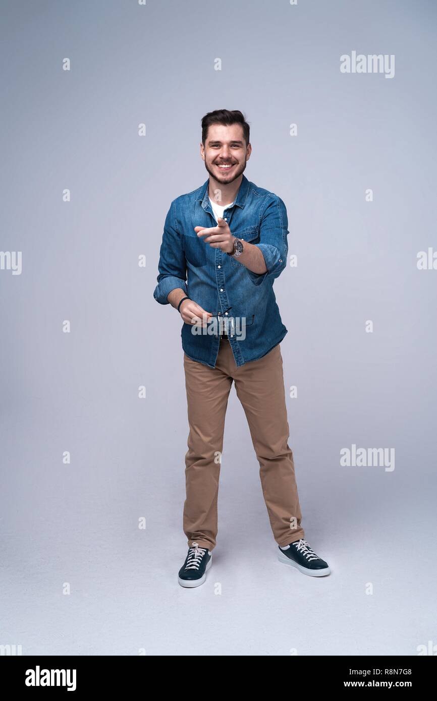 Full length portrait of happy handsome young man isolated on gray ...
