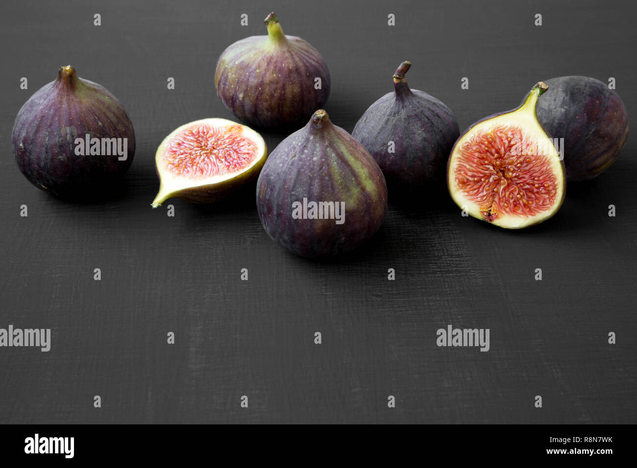Fresh figs on black background, side view. Closeup. Stock Photo