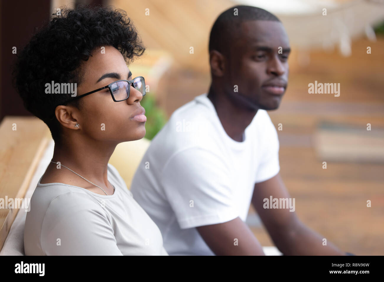 Serious African American woman sitting in cafe, looking in dista Stock Photo