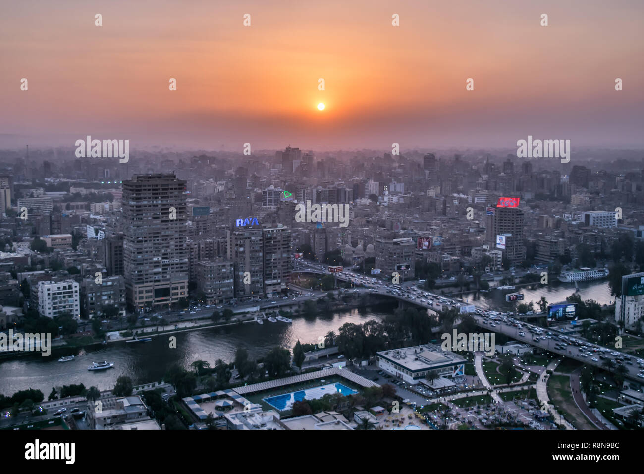 Sunset scene from the top of cairo tower in Egypt shows the nile , the city , buildings and bridge Stock Photo