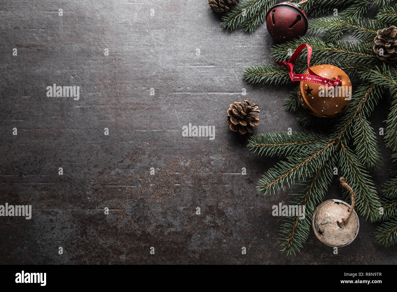 Top of view christmas decorations jingle bells fir tree pine cones on ...