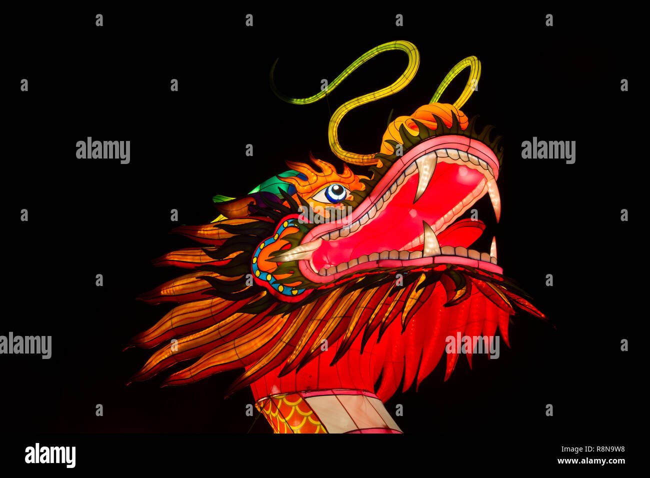 Fierce dragon face paper sculpture shining in the dark at a Asian lantern festival. Stock Photo