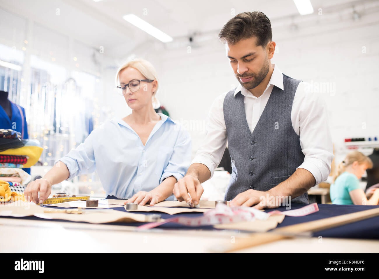 Tailors Working at Table in Atelier Studio Stock Photo Alamy
