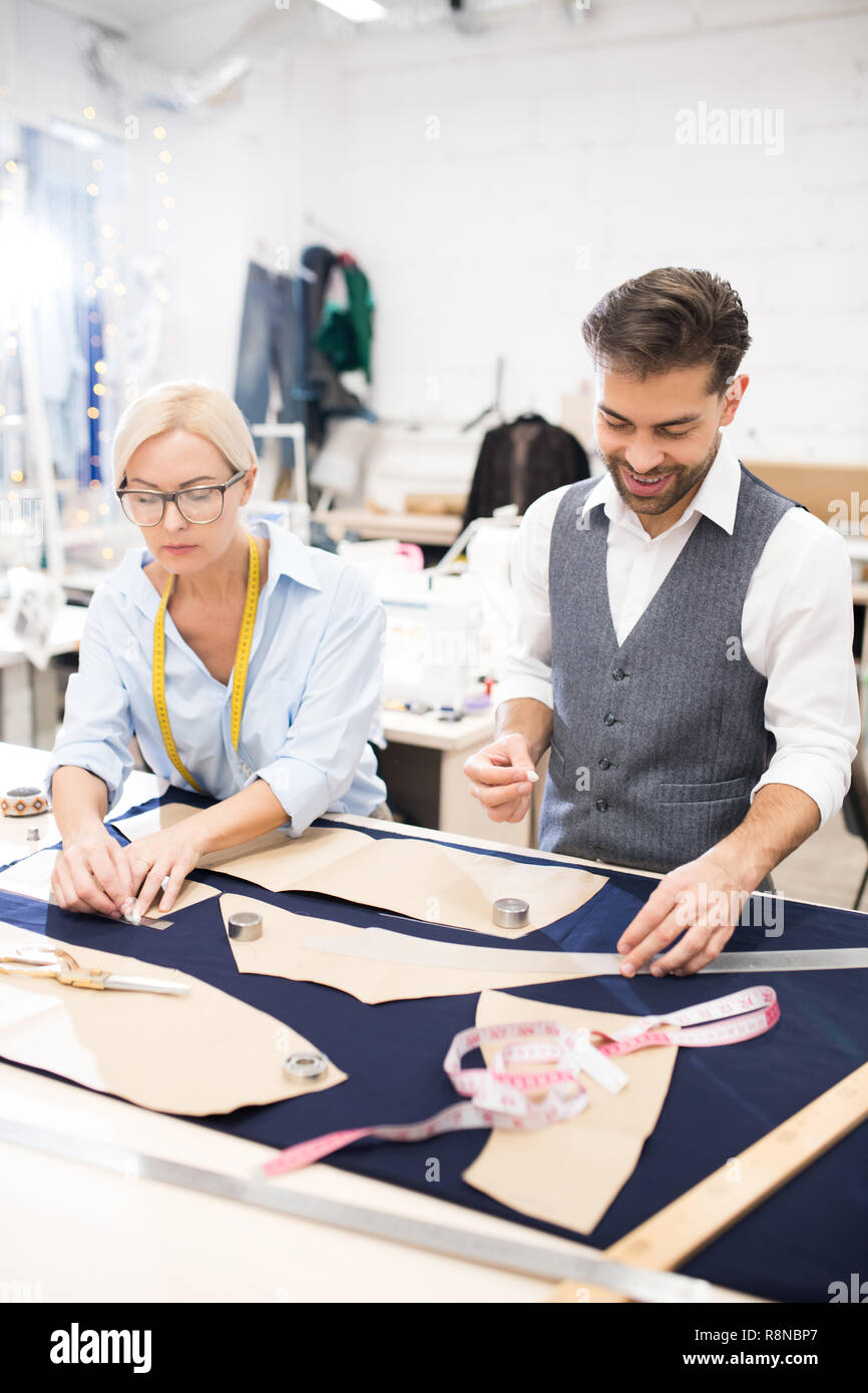 Tailors Working at Table in Atelier Stock Photo Alamy