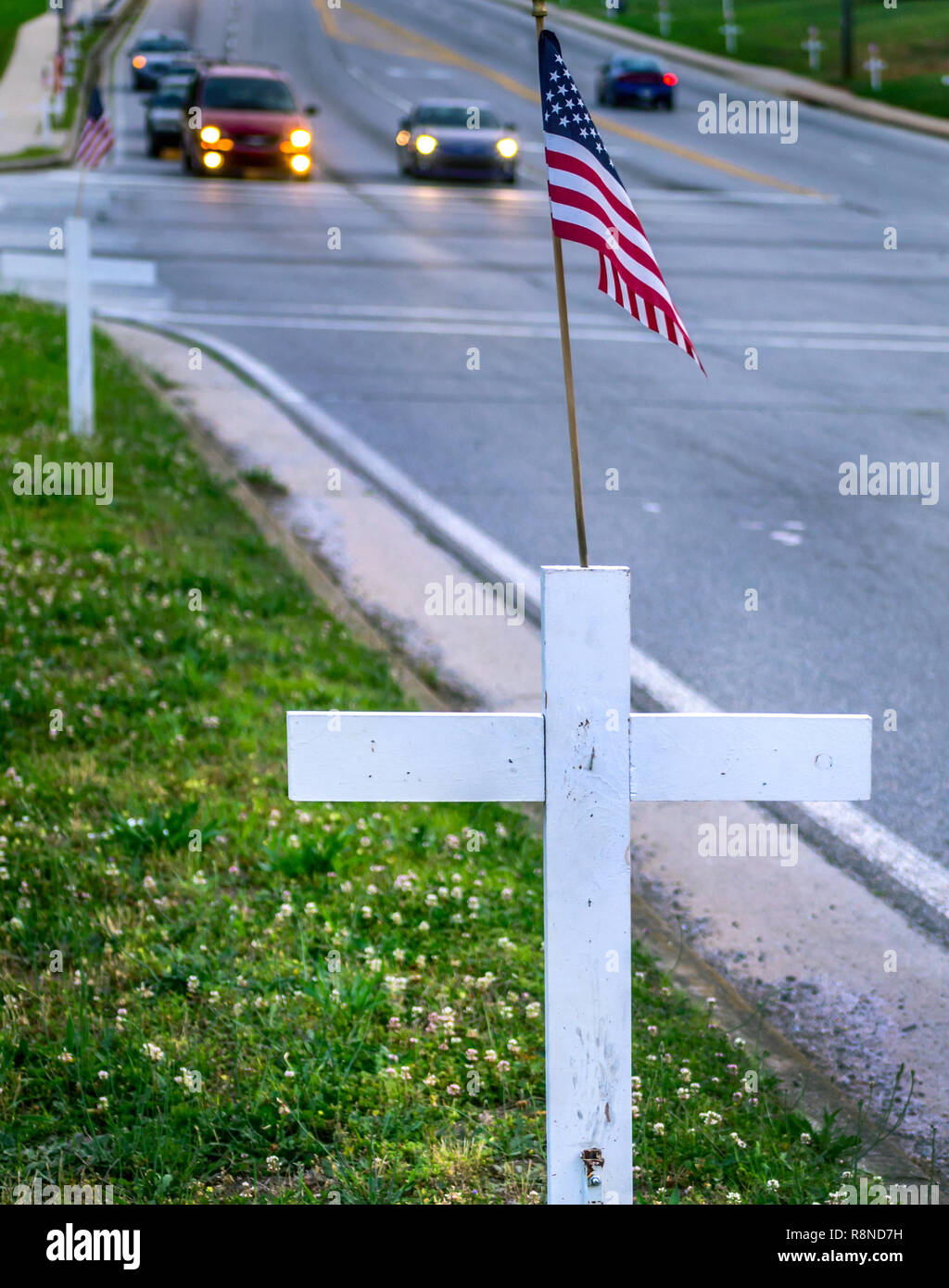 White crosses line New Peachtree Road in Doraville, Georgia, May 29, 2014. The crosses bear the names of the town's fallen war veterans. Stock Photo