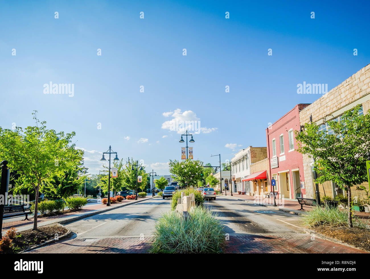Cars pass down Stone Mountain Village's Main Street in Stone Mountain