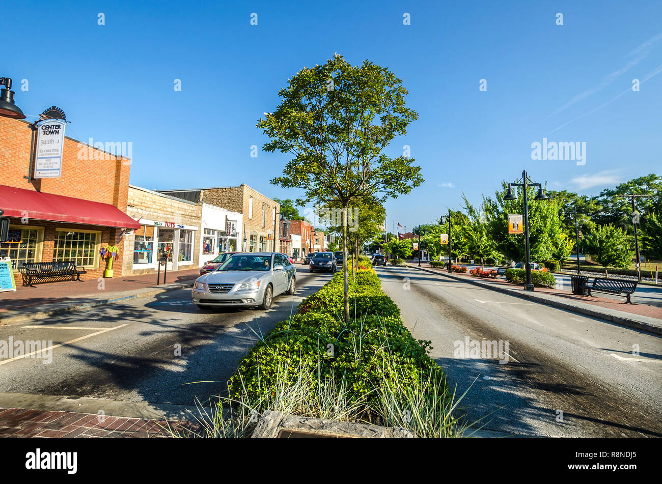 Cars pass down Stone Mountain Village's Main Street in Stone Mountain