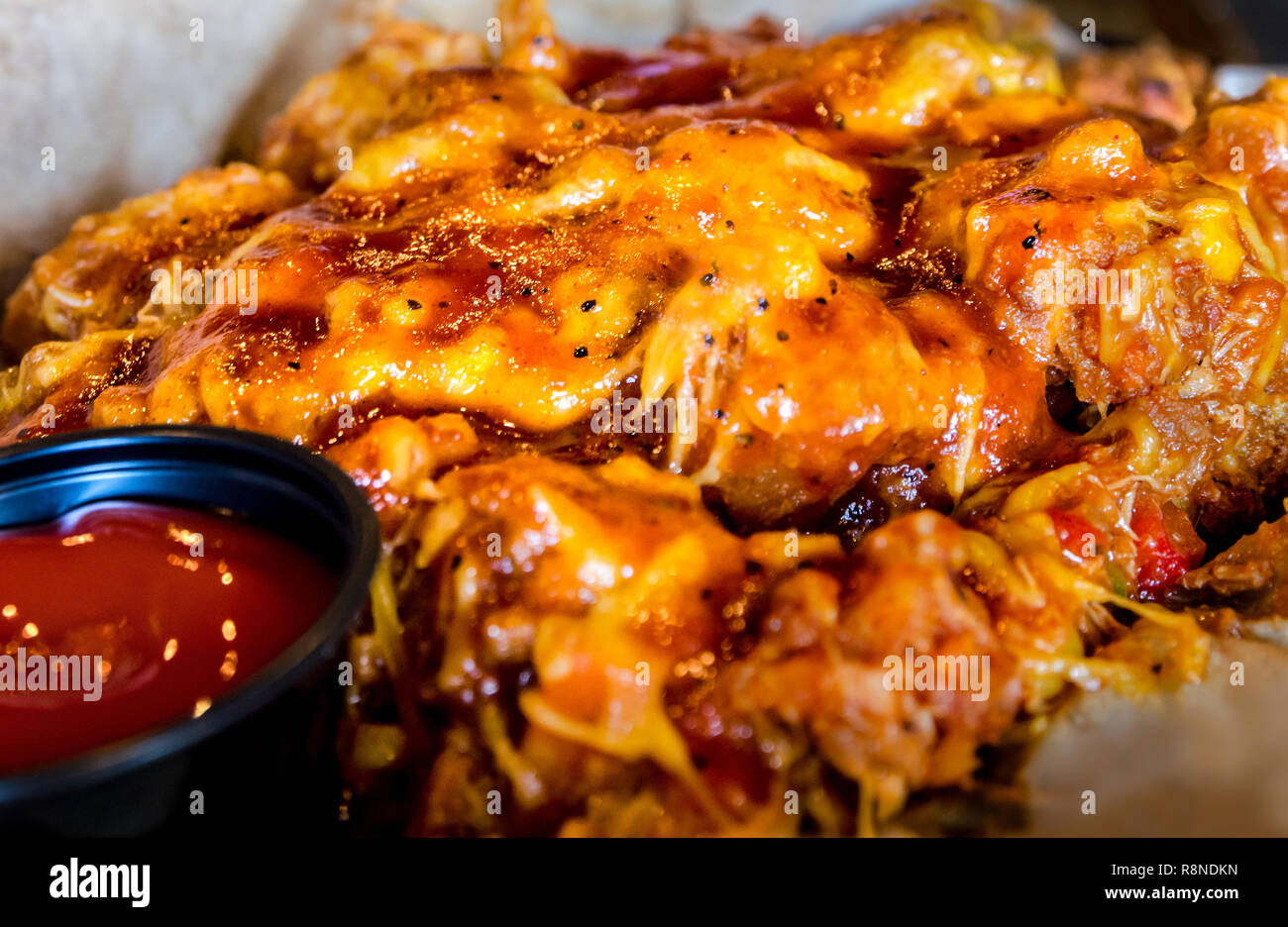 The 'tot stack' at The Local No. 7 in downtown Tucker, Georgia features golden brown tater tots topped with Brunswick stew and cheddar cheese. Stock Photo