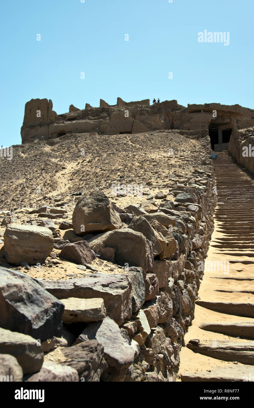 Steep steps lead to the Tombs of the Nobles, ancient rock-cut tombs of officials of the Egyptian court on a hill overlooking the Nile at Aswan Egypt. Stock Photo