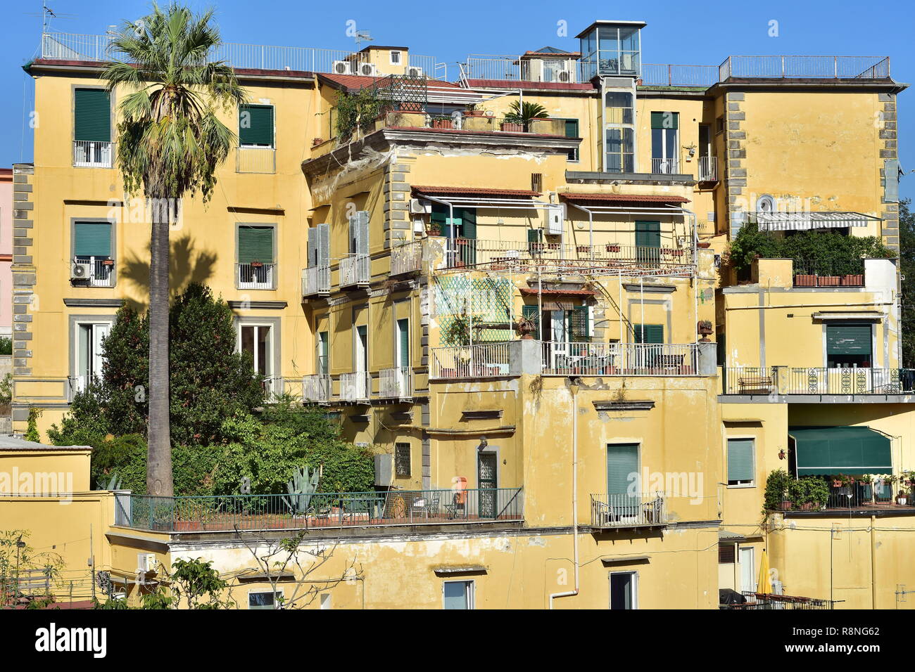 Multi story yellow Mediterranean house with terraces and flat roof on sea  coast in Naples in Italy Stock Photo - Alamy, image size:1300x956