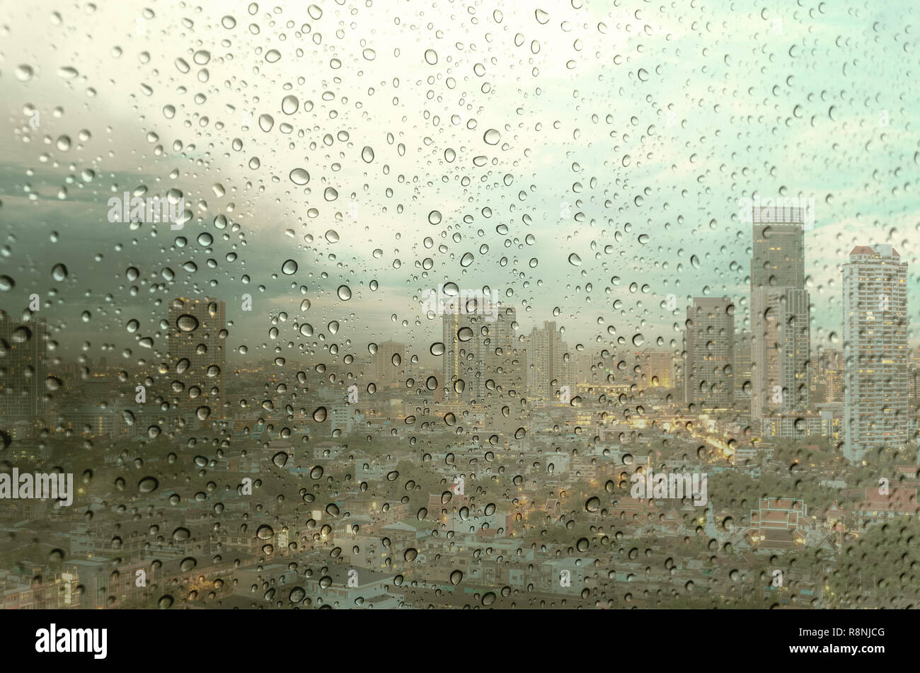 Waterdrops on a glass surface windows with cityscape background Stock Photo
