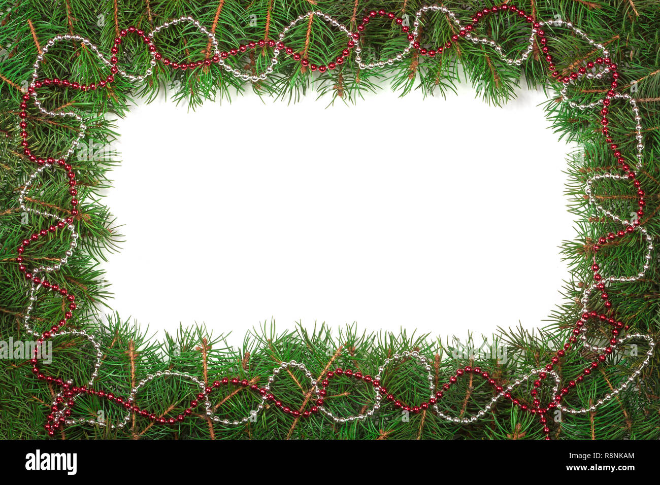Christmas frame made of fir branches decorated with beads isolated on ...