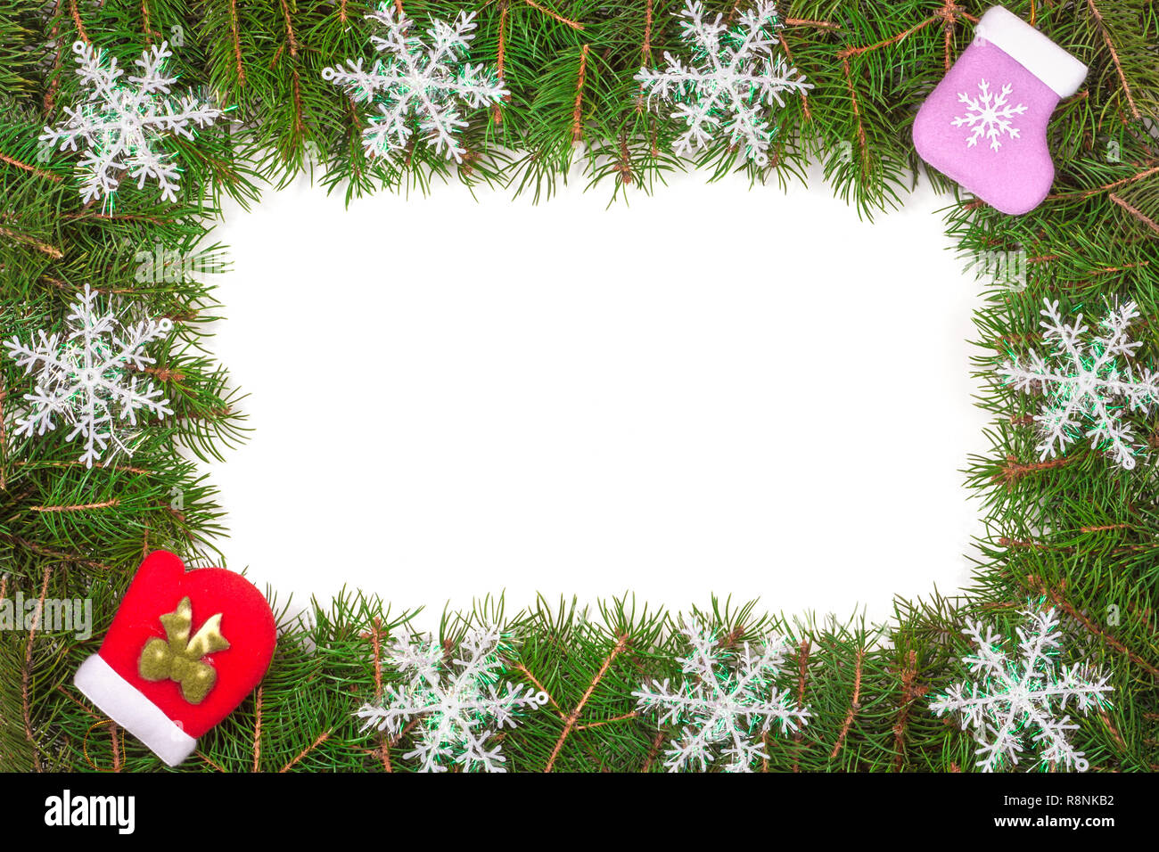 Christmas frame made of fir branches decorated with snowflakes mitten ...