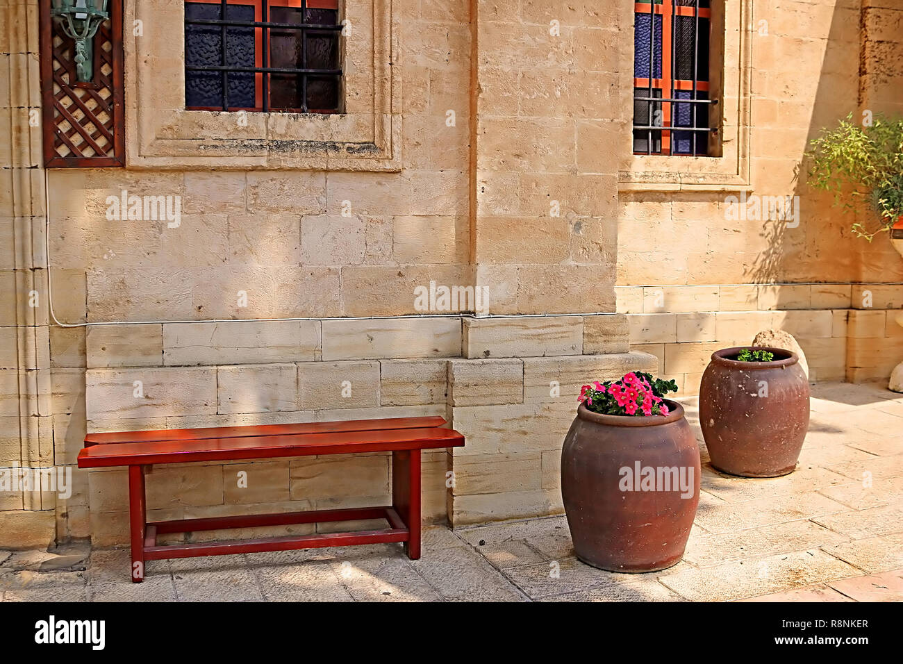 Bench and wine bowls with flowers near the Cana greek orthodox wedding