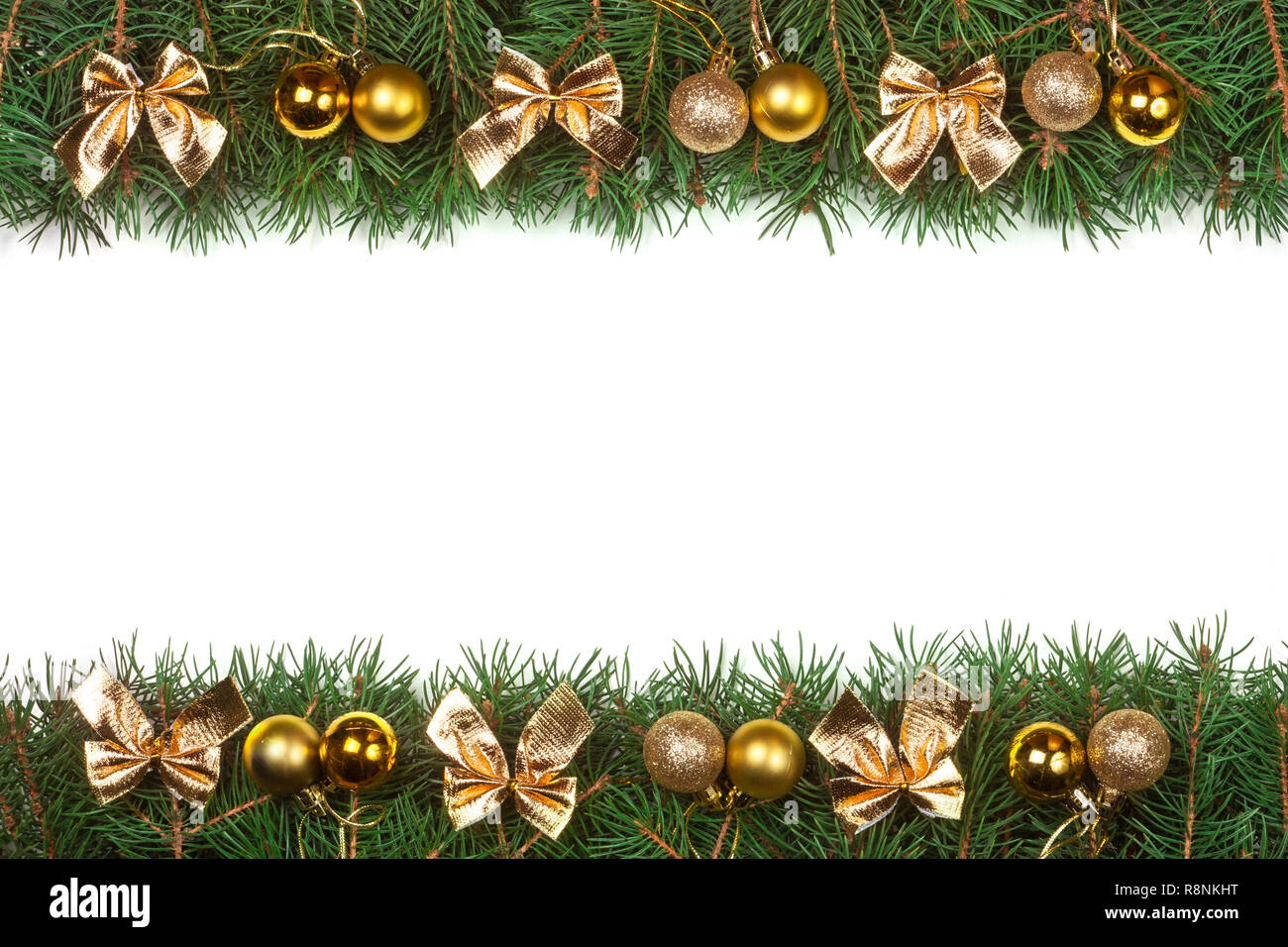 Christmas frame made of fir branches decorated with golden balls and ...