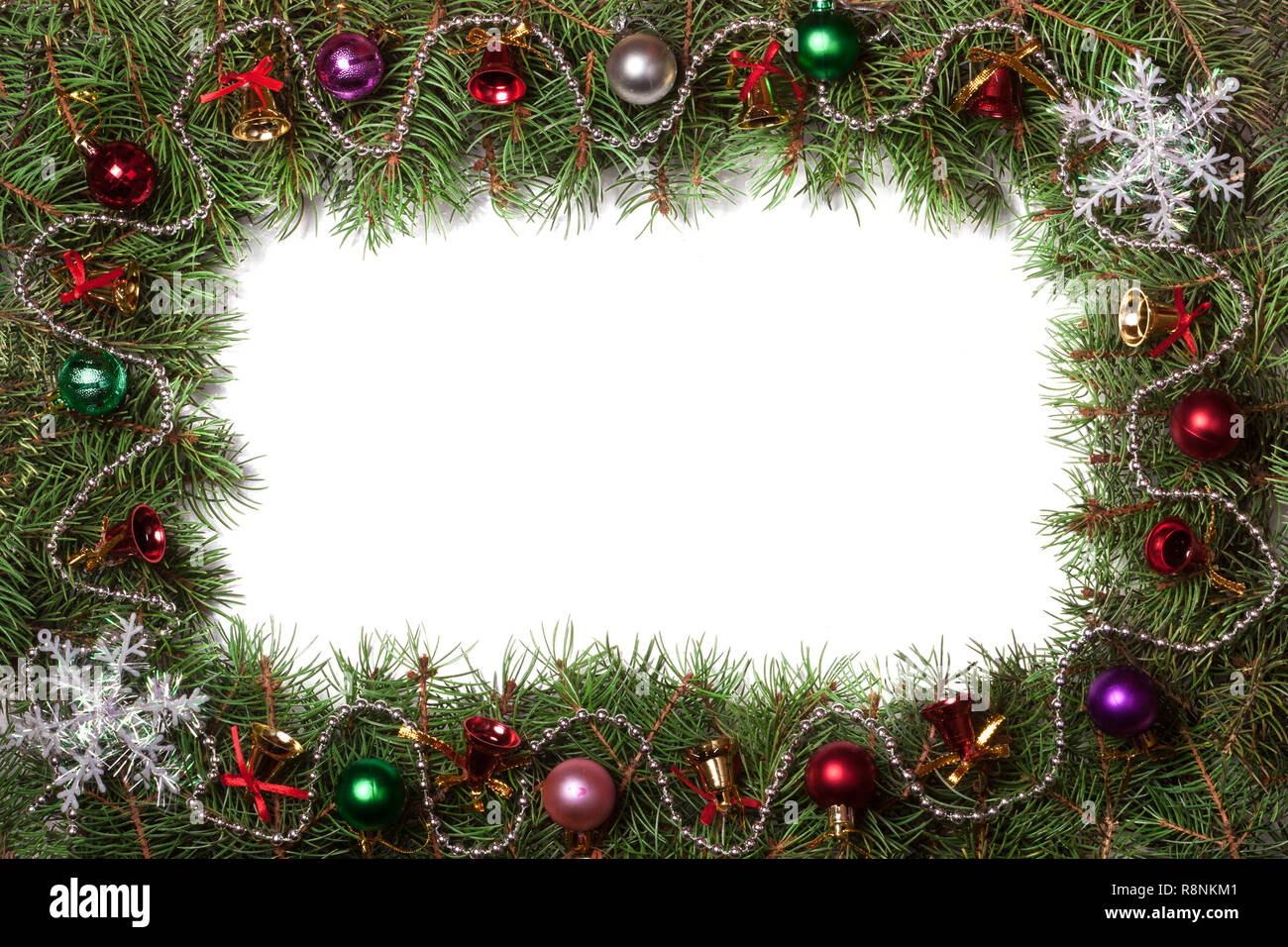 Christmas frame made of fir branches decorated with bells and balls ...