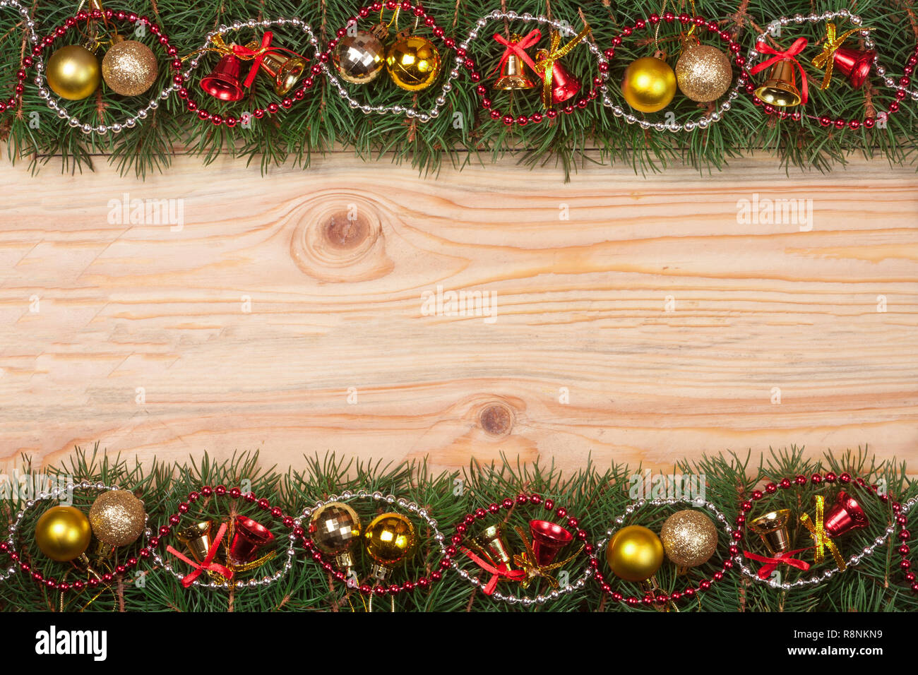 Christmas frame made of fir branches decorated with bells beads and ...