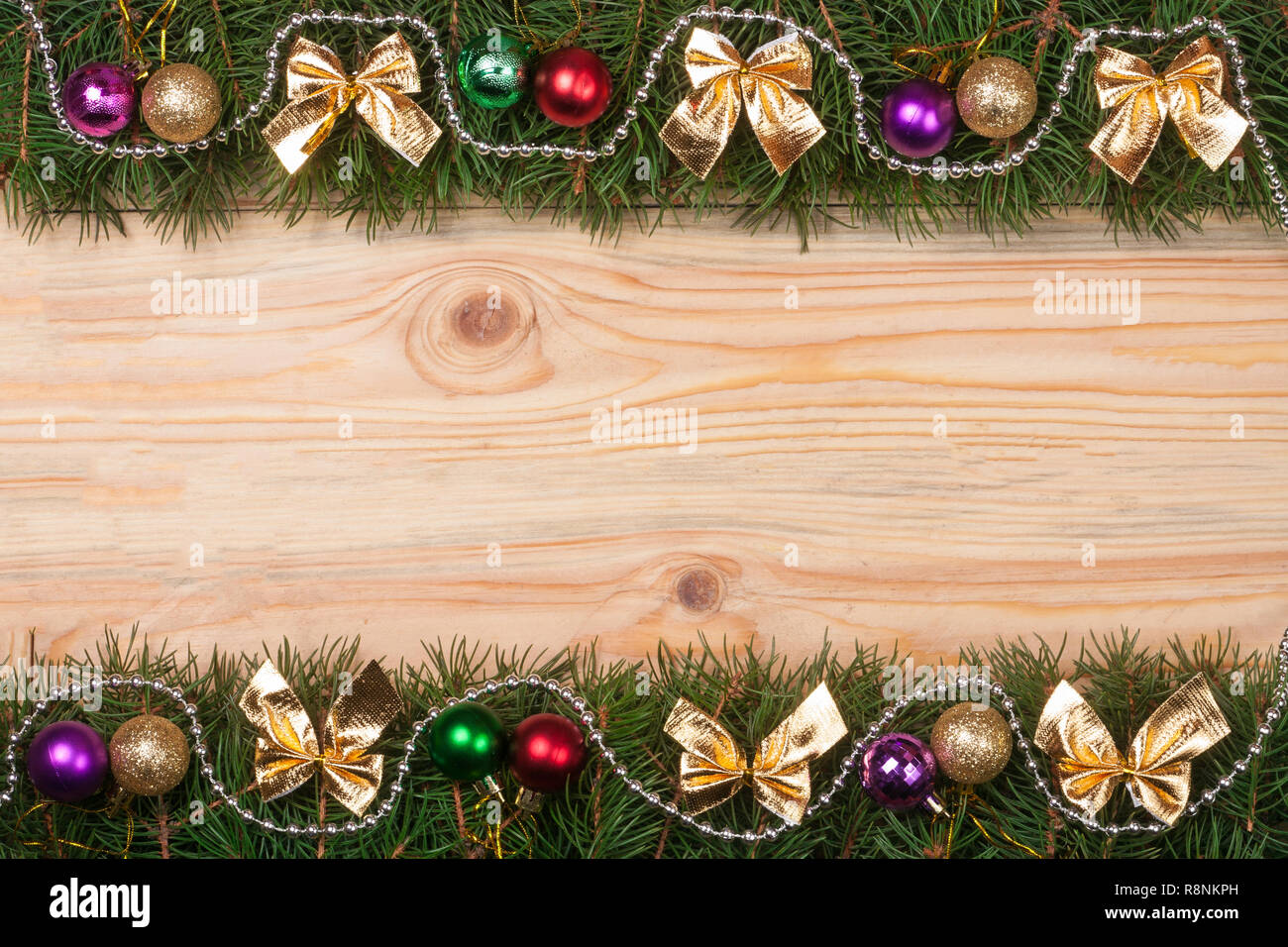 Christmas frame made of fir branches decorated with golden bows beads ...