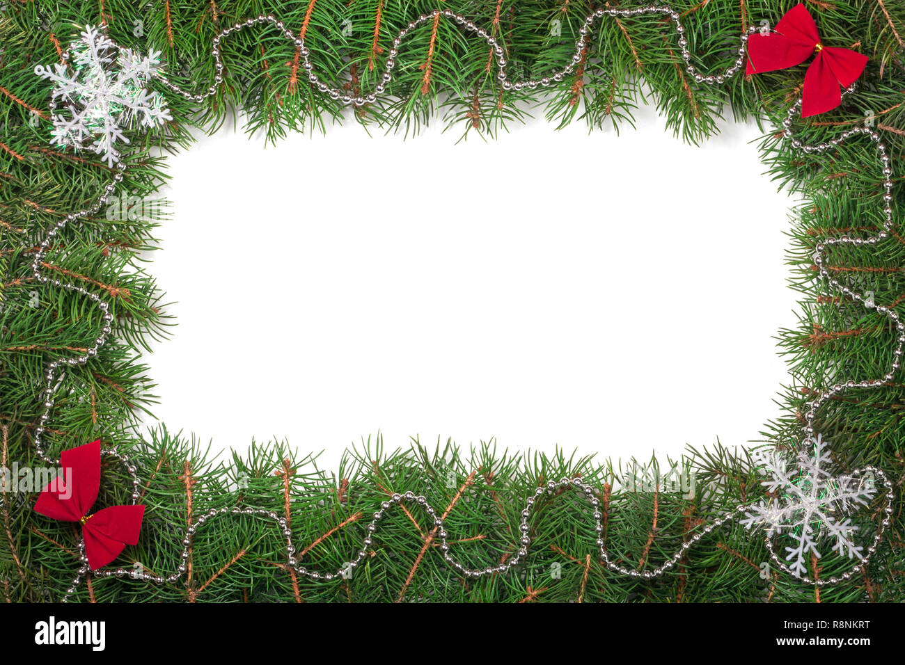 Christmas frame made of fir branches decorated with bows and snowflakes ...