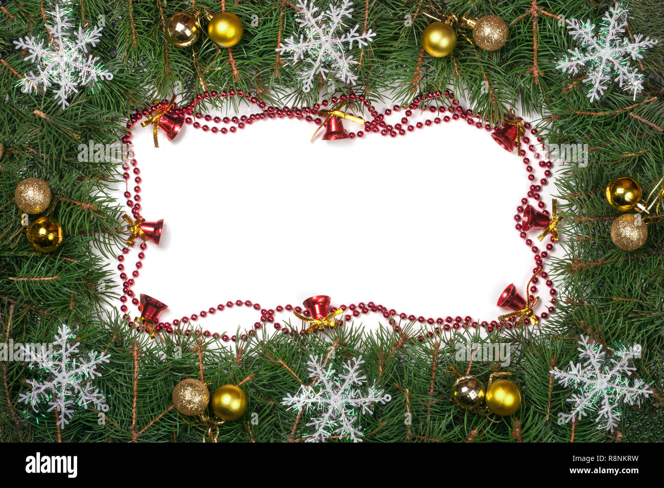 Christmas frame made of fir branches decorated with balls bells and ...