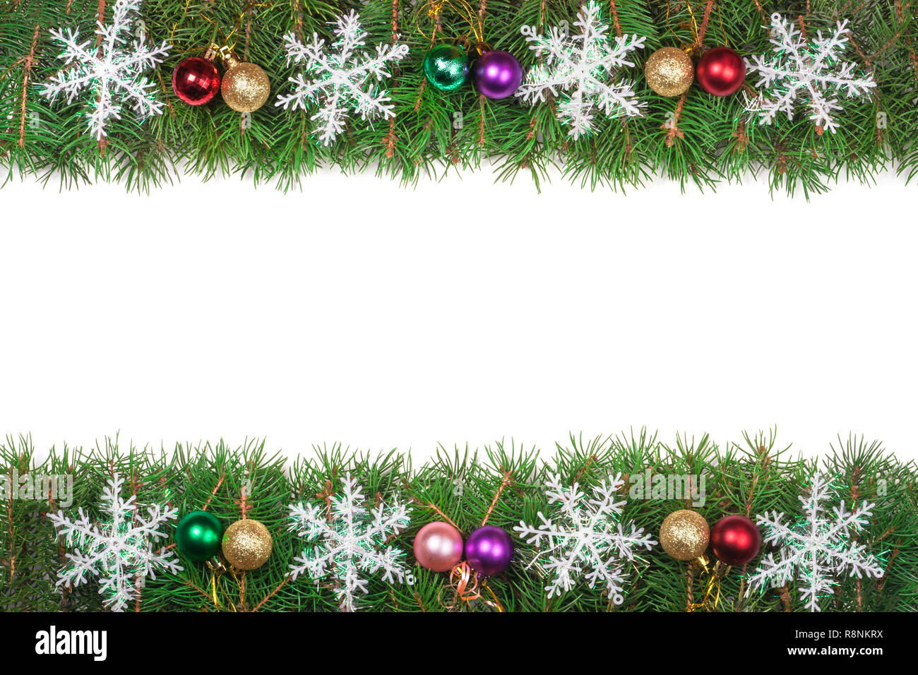 Christmas frame made of fir branches decorated with colored balls and ...