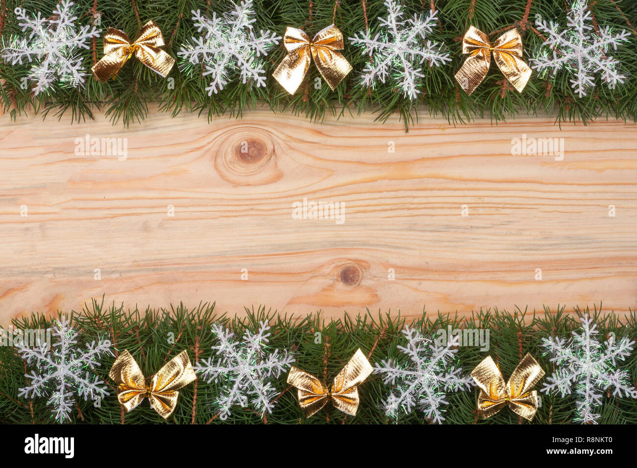 Christmas frame made of fir branches decorated with snowflakes and gold ...